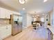 Updated kitchen featuring stainless steel refrigerator and view into living area at 430 Thornbush Trce, Lawrenceville, GA 30046