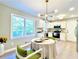 Eat-in kitchen featuring modern appliances, subway tile backsplash, and a breakfast nook with natural light at 430 Thornbush Trce, Lawrenceville, GA 30046