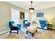 Bright living room featuring contemporary furnishings, stylish light fixture, and colorful accents at 430 Thornbush Trce, Lawrenceville, GA 30046