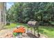 Backyard patio features a grill and outdoor space for entertaining at 6341 Lake Valley Pt, Lithonia, GA 30058