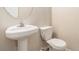 Bathroom with a classic pedestal sink and standard toilet at 6341 Lake Valley Pt, Lithonia, GA 30058