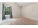 Bright bedroom with a large window offering views of the trees at 6341 Lake Valley Pt, Lithonia, GA 30058