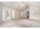 Large bedroom featuring a ceiling fan and multiple entryways at 6341 Lake Valley Pt, Lithonia, GA 30058