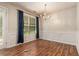 Open dining room with laminate flooring and a chandelier at 6341 Lake Valley Pt, Lithonia, GA 30058