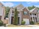 Charming two-story home with brick facade, second-story balcony, and attached one-car garage at 6341 Lake Valley Pt, Lithonia, GA 30058