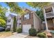 Side view of a charming two-story home with brick facade and attached one-car garage at 6341 Lake Valley Pt, Lithonia, GA 30058