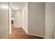 Hallway with wood-look flooring that leads to the living room with fireplace at 6341 Lake Valley Pt, Lithonia, GA 30058