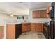 Kitchen with wood cabinets and laminate countertops, open to an adjacent living area at 6341 Lake Valley Pt, Lithonia, GA 30058