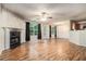 Large living room has a fireplace, windows, and laminate flooring at 6341 Lake Valley Pt, Lithonia, GA 30058