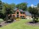 Beautiful brick home with a two-car garage, manicured lawn, and well-maintained landscaping at 710 Larkspur Nw Blvd, Acworth, GA 30102