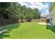 A spacious, grassy backyard with mature trees and a wood fence at 1755 Rutland Pass Dr, Lawrenceville, GA 30045