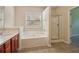 Bathroom featuring a separate shower and soaking tub at 1755 Rutland Pass Dr, Lawrenceville, GA 30045