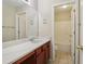 This bathroom includes a double vanity, white countertop, and tile floor at 1755 Rutland Pass Dr, Lawrenceville, GA 30045