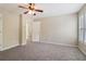 A bright bedroom features neutral walls, carpet, and a ceiling fan at 1755 Rutland Pass Dr, Lawrenceville, GA 30045