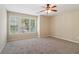 A comfortable bedroom features neutral walls, plush carpet, and three windows for natural lighting at 1755 Rutland Pass Dr, Lawrenceville, GA 30045
