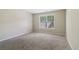 This bedroom has neutral walls, carpet, and a window allowing plenty of natural light at 1755 Rutland Pass Dr, Lawrenceville, GA 30045