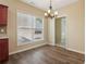Bright breakfast nook with hardwood flooring, view to the exterior, and modern chandelier at 1755 Rutland Pass Dr, Lawrenceville, GA 30045