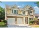 Charming two-story home with a brick and siding facade, featuring an attached two-car garage at 1755 Rutland Pass Dr, Lawrenceville, GA 30045