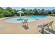 Community pool area with lounge chairs, a central fountain, and clear blue water for relaxation and recreation at 1755 Rutland Pass Dr, Lawrenceville, GA 30045