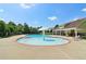 Community pool with a mushroom fountain, ample seating, and nearby clubhouse for residents' enjoyment at 1755 Rutland Pass Dr, Lawrenceville, GA 30045