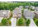 An aerial view of the home showcasing its location in a neighborhood surrounded by lush green trees at 1830 Secretariat Gait Way, Suwanee, GA 30024
