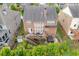 Aerial shot of the back of the home featuring the deck, patio, and spacious backyard at 1830 Secretariat Gait Way, Suwanee, GA 30024