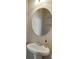 Cozy bathroom with a pedestal sink and classic oval mirror at 1830 Secretariat Gait Way, Suwanee, GA 30024