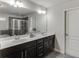 Bathroom featuring dual sinks with a large mirror and vanity at 1830 Secretariat Gait Way, Suwanee, GA 30024
