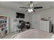 Bright bedroom with carpet, ceiling fan, large window, and closet with dresser at 1830 Secretariat Gait Way, Suwanee, GA 30024