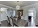 An inviting dining room with stylish lighting, neutral paint, archway to kitchen and decorative molding at 1830 Secretariat Gait Way, Suwanee, GA 30024
