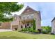 Inviting brick residence boasting a meticulously maintained lawn, a covered porch and mature landscaping at 1830 Secretariat Gait Way, Suwanee, GA 30024