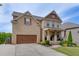 Charming brick home featuring a two-car garage, covered porch and manicured landscaping enhancing its curb appeal at 1830 Secretariat Gait Way, Suwanee, GA 30024