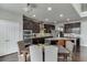Modern kitchen featuring dark cabinetry, granite counters, stainless appliances, and a center island at 1830 Secretariat Gait Way, Suwanee, GA 30024