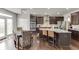 Spacious kitchen features stainless steel appliances, dark wood cabinets, and a large island with barstool seating at 1830 Secretariat Gait Way, Suwanee, GA 30024