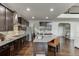 Open-concept kitchen boasts stainless appliances, granite countertops, and a center island with seating at 1830 Secretariat Gait Way, Suwanee, GA 30024