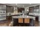 Stylish kitchen featuring dark wood cabinets, granite countertops, and stainless steel appliances at 1830 Secretariat Gait Way, Suwanee, GA 30024