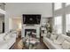 Inviting living room features a fireplace, a large TV, and modern furniture arrangements at 1830 Secretariat Gait Way, Suwanee, GA 30024