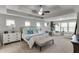 Large primary bedroom with neutral tones, tray ceiling, carpet floors, and lots of windows at 1830 Secretariat Gait Way, Suwanee, GA 30024