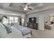 Spacious main bedroom featuring a ceiling fan, sitting area and connecting bathroom at 1830 Secretariat Gait Way, Suwanee, GA 30024