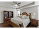 Well-lit main bedroom featuring dark wood floors, bookshelf and tray ceiling at 1830 Secretariat Gait Way, Suwanee, GA 30024