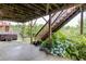 View of the backyard patio with a hot tub and a staircase leading to the upper level deck at 1830 Secretariat Gait Way, Suwanee, GA 30024