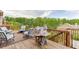 Wooden patio featuring an outdoor grill and dining area with a wooded view at 1830 Secretariat Gait Way, Suwanee, GA 30024