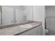 The bathroom features a long granite vanity, large mirror, white cabinets, and a shower-tub at 230 Waters Edge Pkwy, Temple, GA 30179