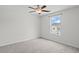 The bedroom features gray carpeting, a ceiling fan, and a window overlooking the neighborhood at 230 Waters Edge Pkwy, Temple, GA 30179