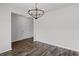 Bright dining room featuring hardwood floors and a modern chandelier, with views into the entry foyer at 230 Waters Edge Pkwy, Temple, GA 30179
