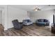 Cozy living room featuring a modern ceiling fan, large television, and comfortable furniture with blue accents at 230 Waters Edge Pkwy, Temple, GA 30179