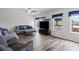 Cozy living room featuring a modern ceiling fan, large television, and comfortable furniture with blue accents at 230 Waters Edge Pkwy, Temple, GA 30179