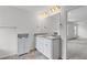 This main bathroom features double sinks, granite countertops, and a cabinet for storage at 230 Waters Edge Pkwy, Temple, GA 30179