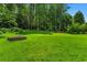 Large lush yard with mature trees and a stone fire pit at 2463 Briarmoor Ne Rd, Atlanta, GA 30345
