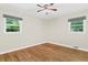 Bright bedroom features hardwood floors, ceiling fan, and natural light from two windows at 2463 Briarmoor Ne Rd, Atlanta, GA 30345